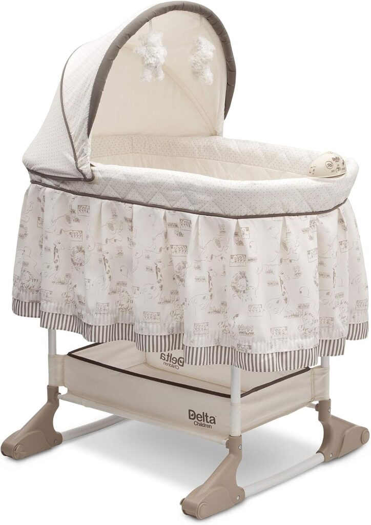 Delta Children Rocking Bedside Bassinet - Portable Crib with Lights Sounds and Vibrations, Play Time Jungle